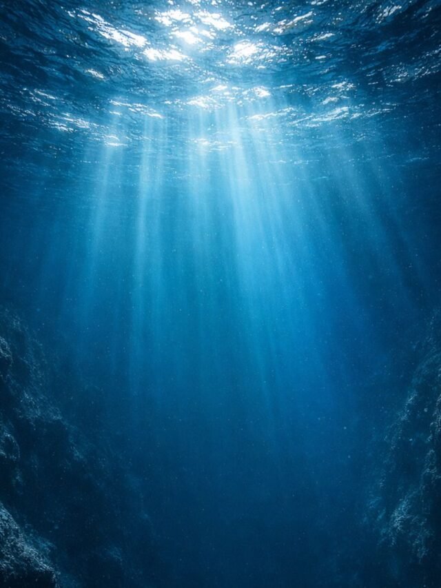 Deep ocean floor with mountains and dark blue water